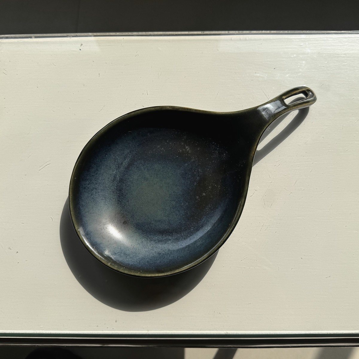 Deep blue-green ceramic dish with an integrated handle